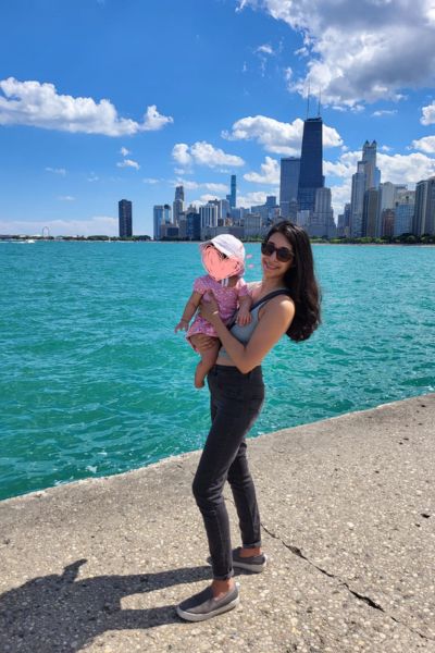 Me holding my toddler in front of the Chicago skyline and Lake Michigan