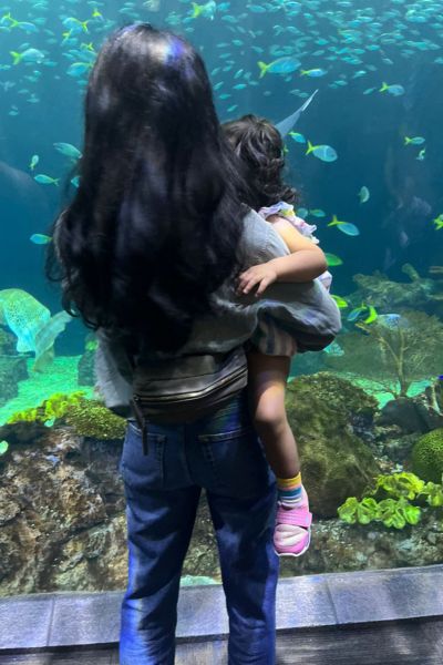 My daughter and I looking at fish at Chicago's Shedd Aquarium, another potential Chicago babymoon activity for you and your partner