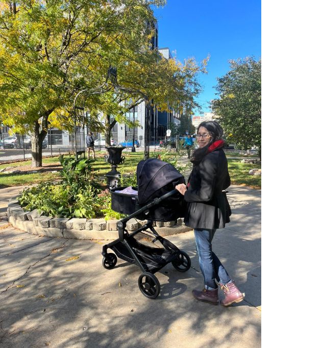 Picture of me with my stroller at the park, in early motherhood