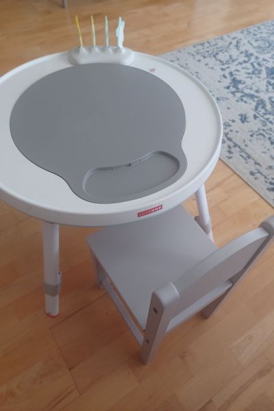 the SkipHop my daughter uses in table form, alongside her wooden gray chair