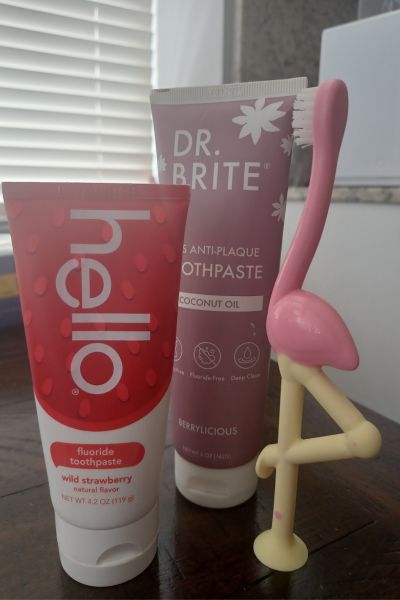 2 of the best toddler toothpastes alongside my daughter's flamingo toothpaste