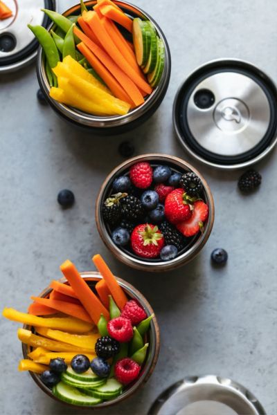 bowls of fresh fruit and veggies - top on the list of tips for flying with a toddler: have snacks!