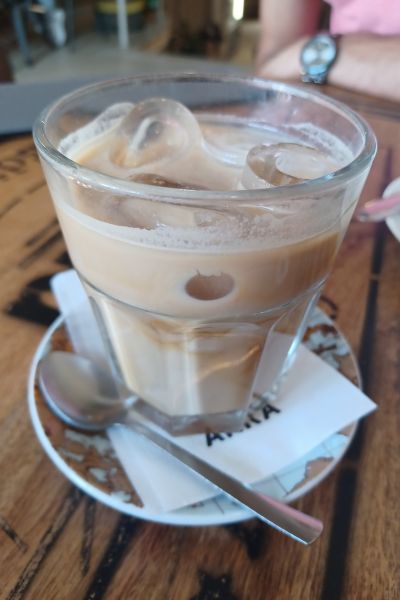 iced coffee in a glass on top of a plate