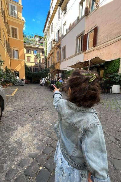 my daughter pointing to a sidewalk in Rome