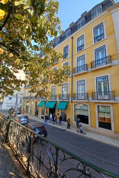 scene of yellow pastel buildings in Lisbon - at your disposal once you act on the tips for flying with a toddler!