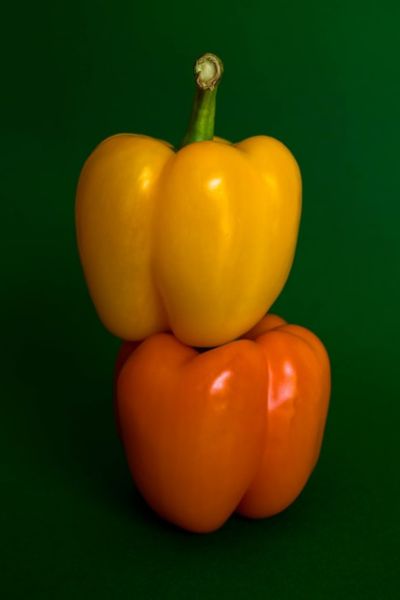 yellow bell pepper atop orange bell pepper